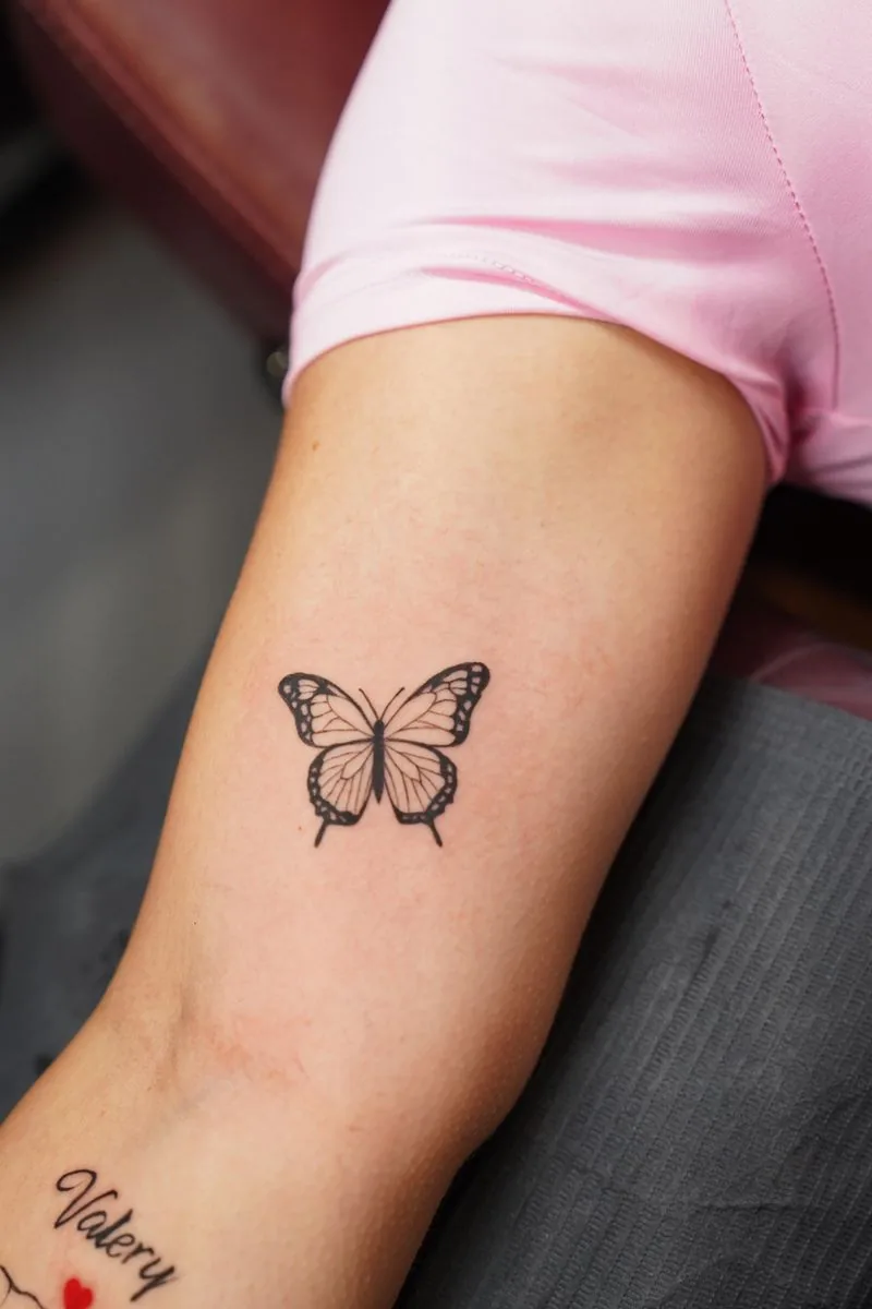 Fine line tattoo: butterfly on the arm