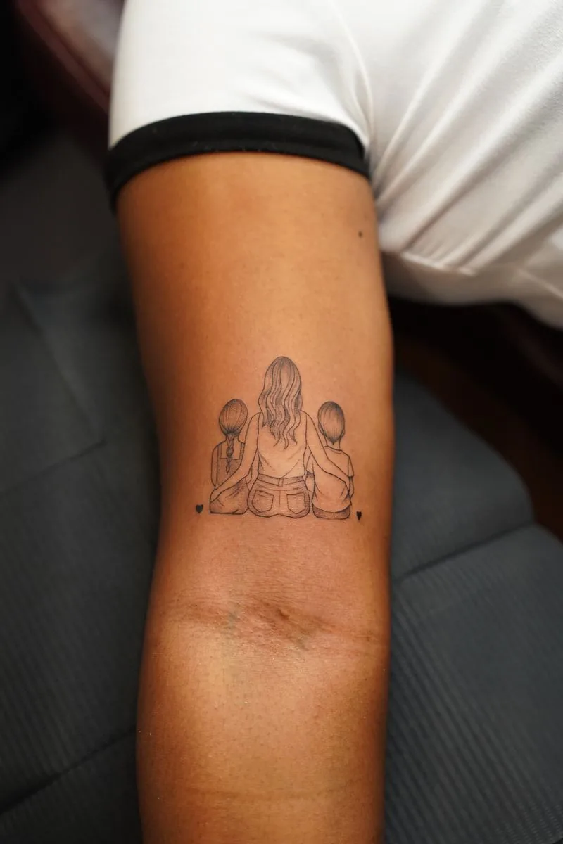 Fine line tattoo: mother with her two children, on the arm